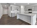 Open kitchen with island, granite countertops, and gray cabinets at 2243 Carpenter Farms Dr, Lincolnton, NC 28092