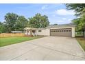 House exterior with a large driveway and attached garage at 134 Amber Ln, Statesville, NC 28677