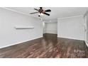 Living room with dark hardwood floors and fireplace at 4754 Hedgemore Dr # T, Charlotte, NC 28209