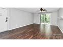 Living room with dark hardwood floors and sliding doors at 4754 Hedgemore Dr # T, Charlotte, NC 28209