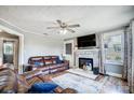 Spacious living room featuring a fireplace and comfortable leather sofas at 115 Abernathy St, Mount Holly, NC 28120