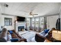 Cozy living room features a fireplace and large TV at 115 Abernathy St, Mount Holly, NC 28120