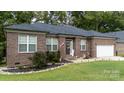 Brick ranch home with a two-car garage and landscaped yard at 133 Ole Eastpointe Dr, York, SC 29745