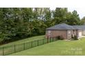 Spacious backyard with a black metal fence and green lawn at 133 Ole Eastpointe Dr, York, SC 29745