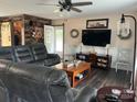 Living room with sectional sofa, TV, and wood accent wall at 4040 Angus Dr, Gastonia, NC 28056