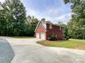 Brick home with a three-car garage and landscaping at 2510 Doster Rd, Monroe, NC 28112