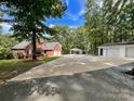 Brick house with attached garage and a long driveway at 2510 Doster Rd, Monroe, NC 28112