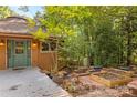 Inviting round house exterior with a green door, deck, and garden at 241 Spring Shore Rd, Statesville, NC 28677
