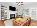 Living room with a fireplace and built-in shelving at 1001 Serel Dr, Matthews, NC 28104