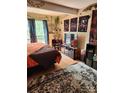 Bedroom with large TV, decorative wall hangings, and rug at 5012 Sardis Rd # D, Charlotte, NC 28270