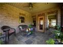 Relaxing screened porch with wicker furniture and tile flooring at 1235 Bob Falls Dr, Shelby, NC 28150