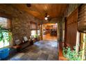 Sunroom with stone wall, wood ceiling and view of kitchen at 1235 Bob Falls Dr, Shelby, NC 28150