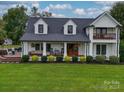 Two story home with white exterior, dark roof, and a large front porch at 540 Harbor Rd, Norwood, NC 28128