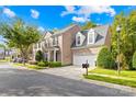 Townhome exterior with a driveway and landscaping at 10320 Berkeley Pond Dr, Charlotte, NC 28277