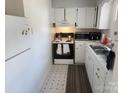 Small kitchen with white cabinets and appliances at 916 Mcalway Rd # D, Charlotte, NC 28211