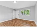 Bright living room featuring hardwood floors and neutral walls at 2409 Thornton Rd, Charlotte, NC 28208