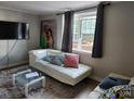 Living room featuring a white couch and a large TV at 910 Mcalway Rd # A, Charlotte, NC 28211