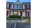 Brick front of charming townhome with landscaping at 7945 Mariners Pointe Cir, Denver, NC 28037