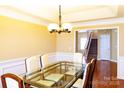 Glass-topped dining table with view of staircase at 9816 Cayenne Dr, Charlotte, NC 28214