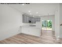 Modern kitchen with gray cabinets, island, and stainless steel appliances at 5151 Tommy Ln # 1103, Stanley, NC 28164