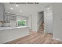 Modern kitchen with gray cabinets, island, and view of backyard at 5151 Tommy Ln # 1103, Stanley, NC 28164