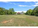 View of the backyard showcasing a large open space and fire pit at 5510 Hoodtown Rd, Sharon, SC 29742