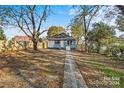 Spacious backyard with a brick pathway leading to the house at 4319 Hovis Rd, Charlotte, NC 28208
