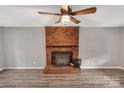 Living room featuring a brick fireplace and wood-look flooring at 511 Colorado Trl, Lincolnton, NC 28092