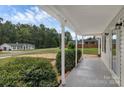 Inviting front porch with ample space, showcasing a well-maintained home and surrounding landscape at 511 Colorado Trl, Lincolnton, NC 28092