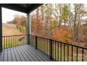 Private deck overlooking wooded area with metal railing and gray composite decking at 440 Nathaniel Way # Brx0041, Charlotte, NC 28213