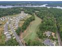 Community overview featuring houses, golf course, and lake at 165 Old Harbor Dr, Mount Gilead, NC 27306