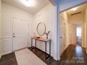 Bright entryway with hardwood floors, console table, and mirror at 165 Old Harbor Dr, Mount Gilead, NC 27306