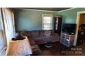 Living room with brown sectional sofa and hardwood floors at 40077 Nc 740 Hwy, New London, NC 28127