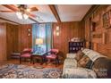Living room with wood paneling, ceiling fan, and comfortable seating at 4537 Sunrise Beach Rd, Catawba, NC 28609