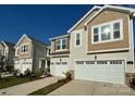 Row of attractive tan and beige townhouses with garages at 6341 Mallow Crossing Lane Ln, Charlotte, NC 28213
