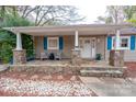 Stone porch with blue shutters and inviting seating area at 9556 Riviera Dr, Sherrills Ford, NC 28673