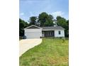 Ranch style home with driveway, landscaped lawn, and spacious yard at 4050 Fairview Ln, Maiden, NC 28650