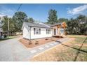 Charming white house with gray roof, new landscaping, and a covered porch at 7025 Nc Hwy 73 E Hwy, Mount Pleasant, NC 28124