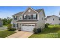 Two-story house with a two-car garage and landscaping at 1814 Mill Creek Ln, Concord, NC 28025