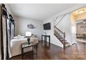 Living room with sectional sofa, hardwood floors, and stairs at 1814 Mill Creek Ln, Concord, NC 28025