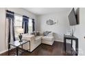 Living room with sectional sofa and hardwood floors at 1814 Mill Creek Ln, Concord, NC 28025