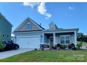 Front view of a charming two-story house with a landscaped yard at 343 Ox Bow Cir, Mount Holly, NC 28120