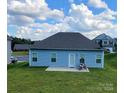 Back of house showing patio and grassy backyard at 343 Ox Bow Cir, Mount Holly, NC 28120