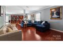 Spacious living room with hardwood floors, sectional sofa, and kitchen view at 5051 Meanna Dr, Clover, SC 29710