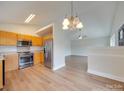 Open kitchen with stainless steel appliances and vaulted ceiling at 1205 Danielle Downs Ct, Concord, NC 28025