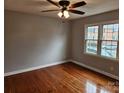 Spacious bedroom with hardwood floors, large windows, and ceiling fan at 910 Mcalway Rd # C, Charlotte, NC 28211
