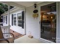 Inviting front porch with seating and storm door at 394 Link Dr, Iron Station, NC 28080