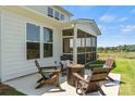 Cozy patio with fire pit and seating area, adjacent to house at 303 Coronado Ave # 60, Matthews, NC 28104