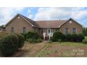 Brick ranch home with landscaped yard and walkway at 139 Sain Rd, Statesville, NC 28625