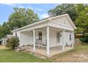 White bungalow with covered porch, offering curb appeal at 900 Alma Ave, Kannapolis, NC 28081